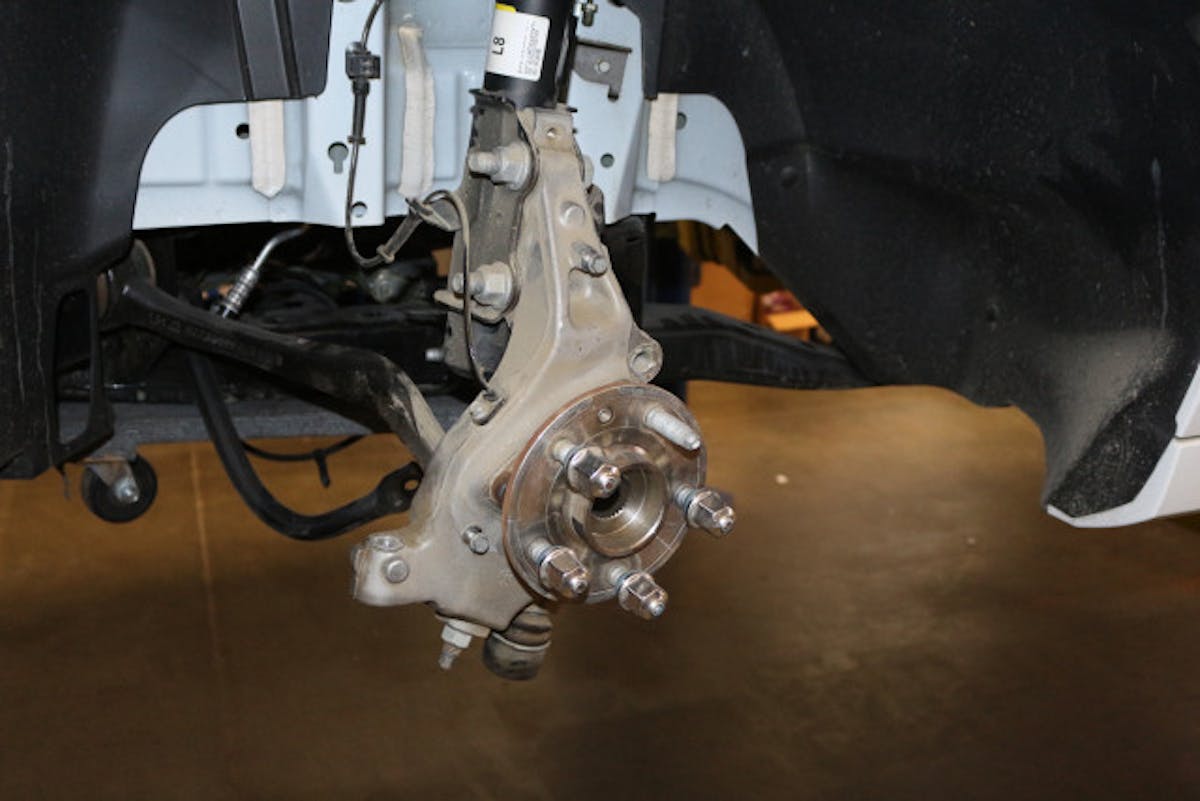 The stock front spindle and hub assembly. Aerospace provides a brake caliper basket that mounts directly to the OEM spindle.