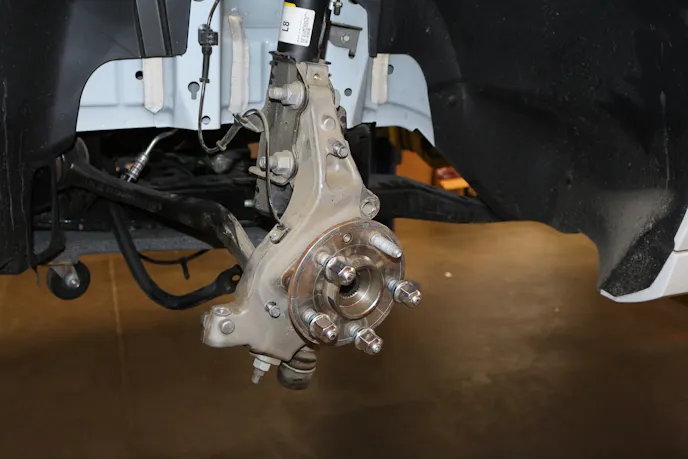 The stock front spindle and hub assembly. Aerospace provides a brake caliper basket that mounts directly to the OEM spindle.