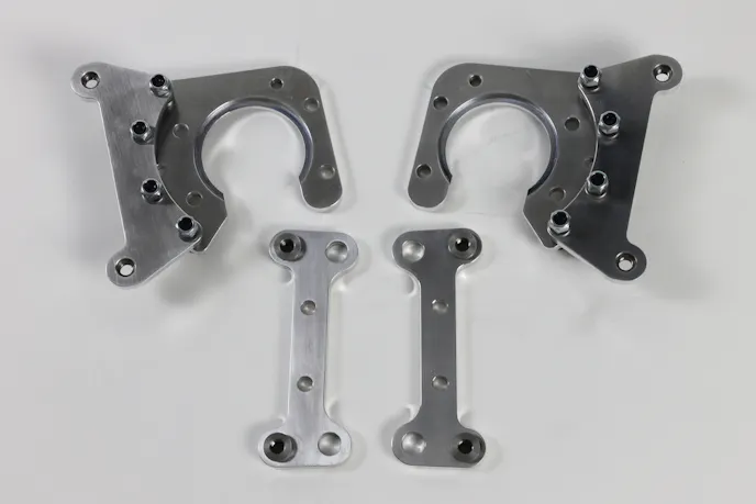 Our rear brake calipers brackets (top) and the front caliper brackets. With the front caliper mount, we're able to use the stock Camaro spindle without any modification.