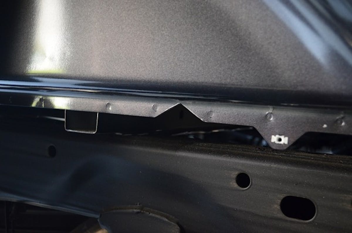 A V-shaped notch was cut into the bed flange to allow the front crossmember to be slid in and across to the other side of the frame.