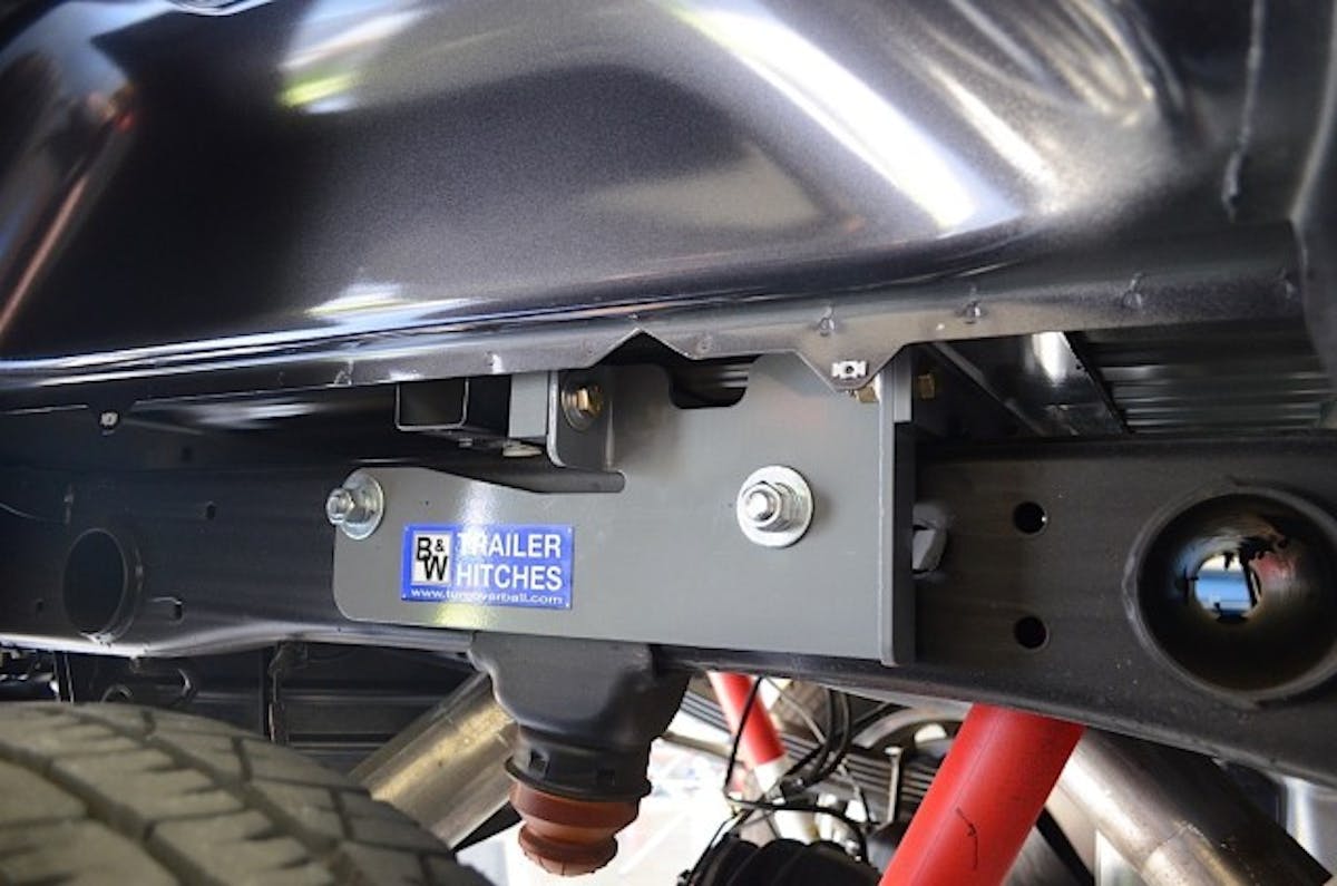 Top: bolt guides are employed to get the side plates mounted to the center section. Bottom: the side plates are successfully attached and bolted to the center section.