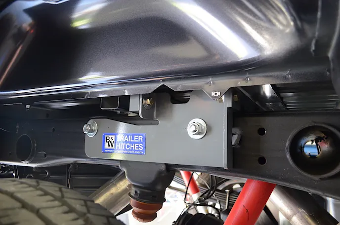 Top: bolt guides are employed to get the side plates mounted to the center section. Bottom: the side plates are successfully attached and bolted to the center section.