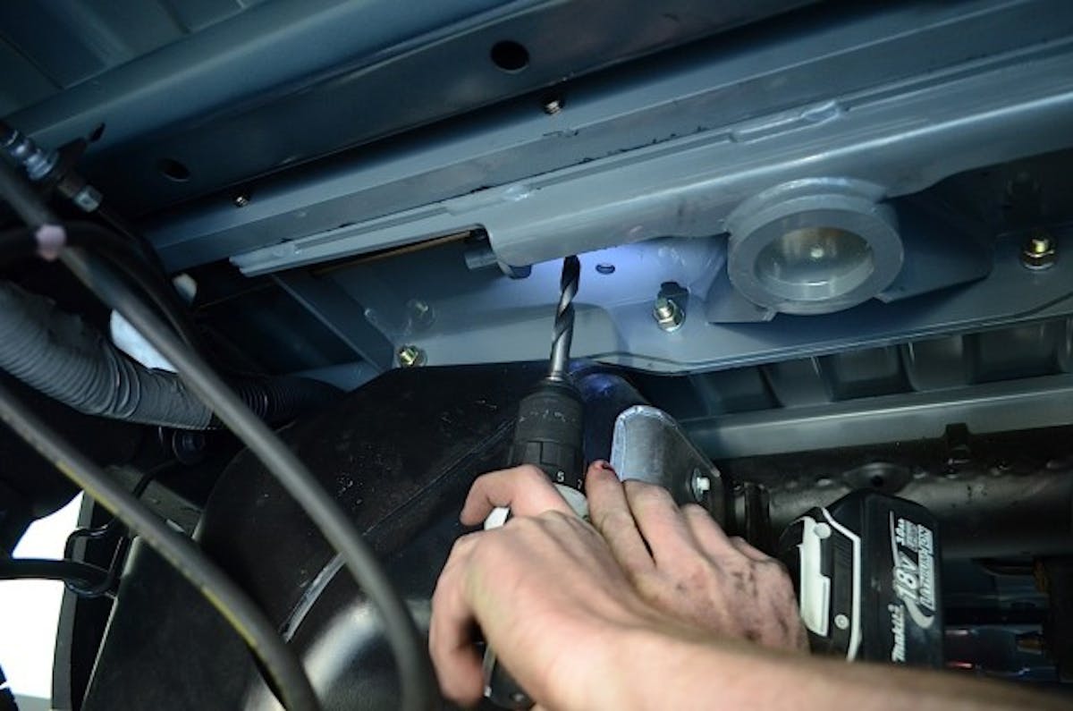 Drilling up and through to the bed using the pre-made bolt holes as a guide, we were able to get the safety spring U-bolt locations lined up correctly.