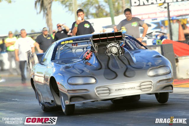 Ken Cruz is sporting new paint this weekend applying the base and clear coat at his shop in Largo, Florida. He had Mark Anderson from Liquid Lenny's Custom's apply the custom flames. The car is looking good but will sit out the rest of the event of a broken fuel line leaned out the engine resulting in losing two connecting rods. Cruz told us there was a lot of fuel spraying and he was just glad it didn't catch fire in the traps.