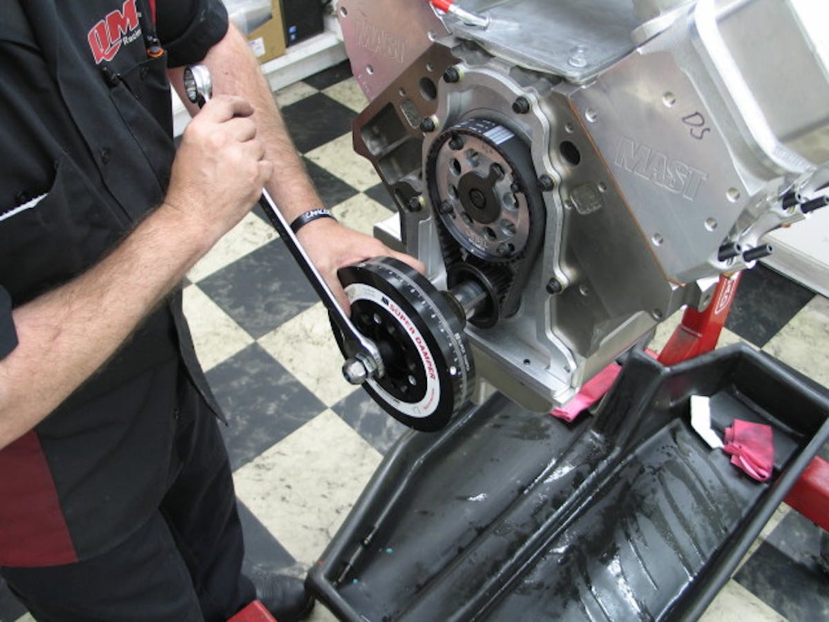 Mike at QMP installing the ATI Super Damper after short block completion. The damper shell is equipped with 4 magnets that will instruct the Holley Dominator EFI system for spark timing.