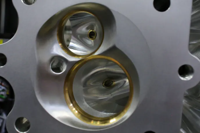 Chamber softening is done on the heads to permit a wider window for tuning adjustments; the amount and angle of softening, along with valve-seat materials is tailored per the application.