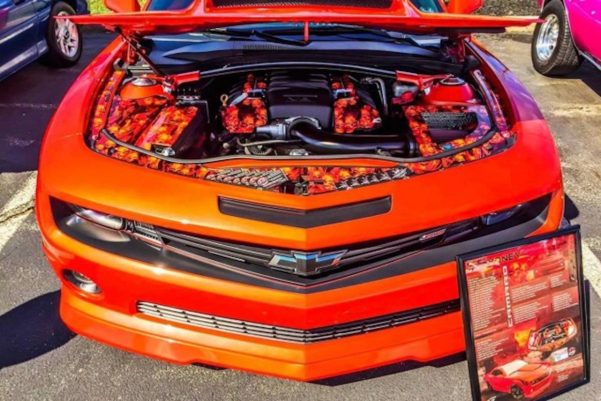 The engine compartment isn't home to just performance mods, the area also has been customized with various vinyl-wrapped components, Classic Industries' accent panels, and a strut tower brace with TPIS brackets.