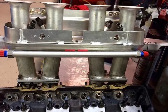 Here is a head with the Lucas fuel injection and slide valve setup installed.