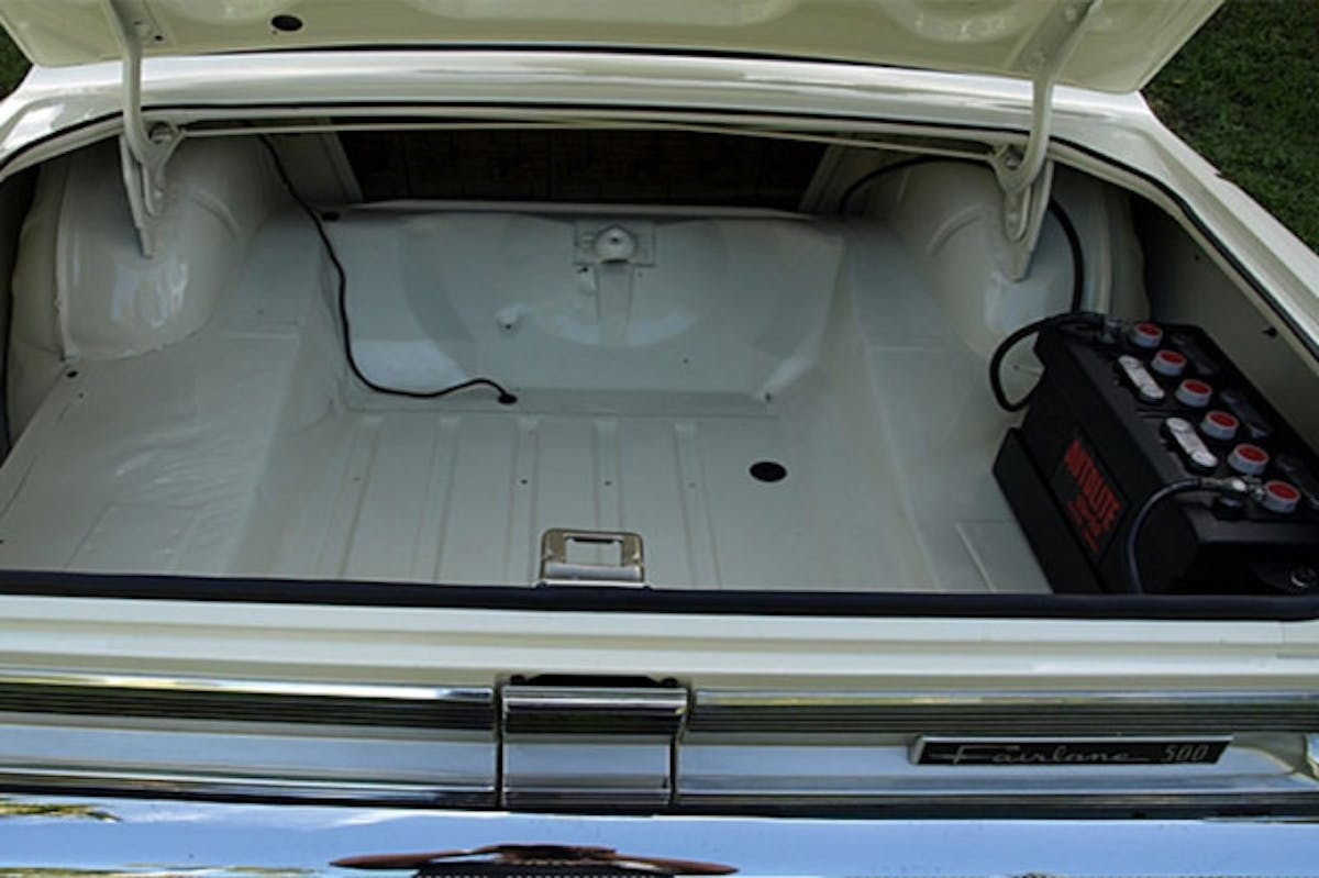 In order to help with weight transfer to the rear tires, the battery was relocated to the trunk, and the standard unit was replaced with this 95-pound beast out of a bus.