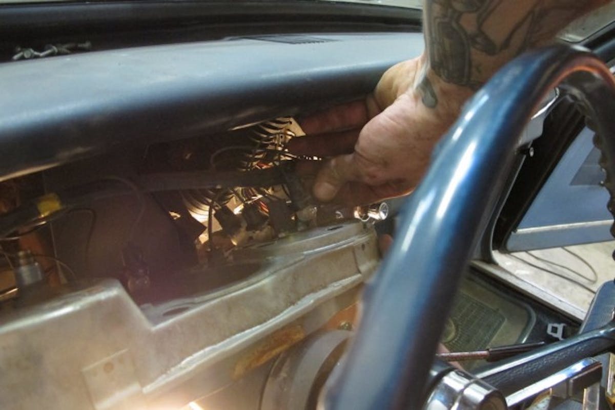 Before the cluster can be removed, the speedometer cable, the gauge lights, and other wires need to be disconnected.