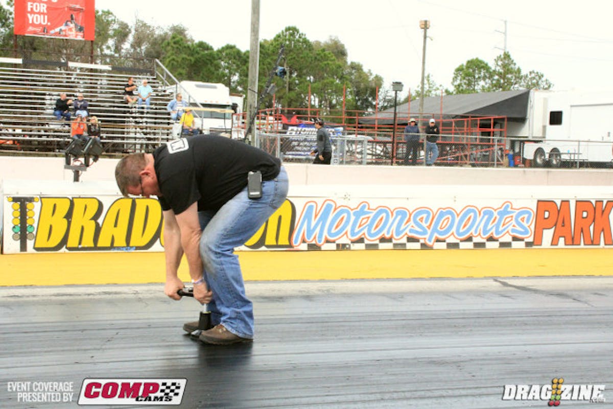 A racer crew member tests the track surface  this morning before first round of heads up eliminations.  Things are looking good so far this morning.