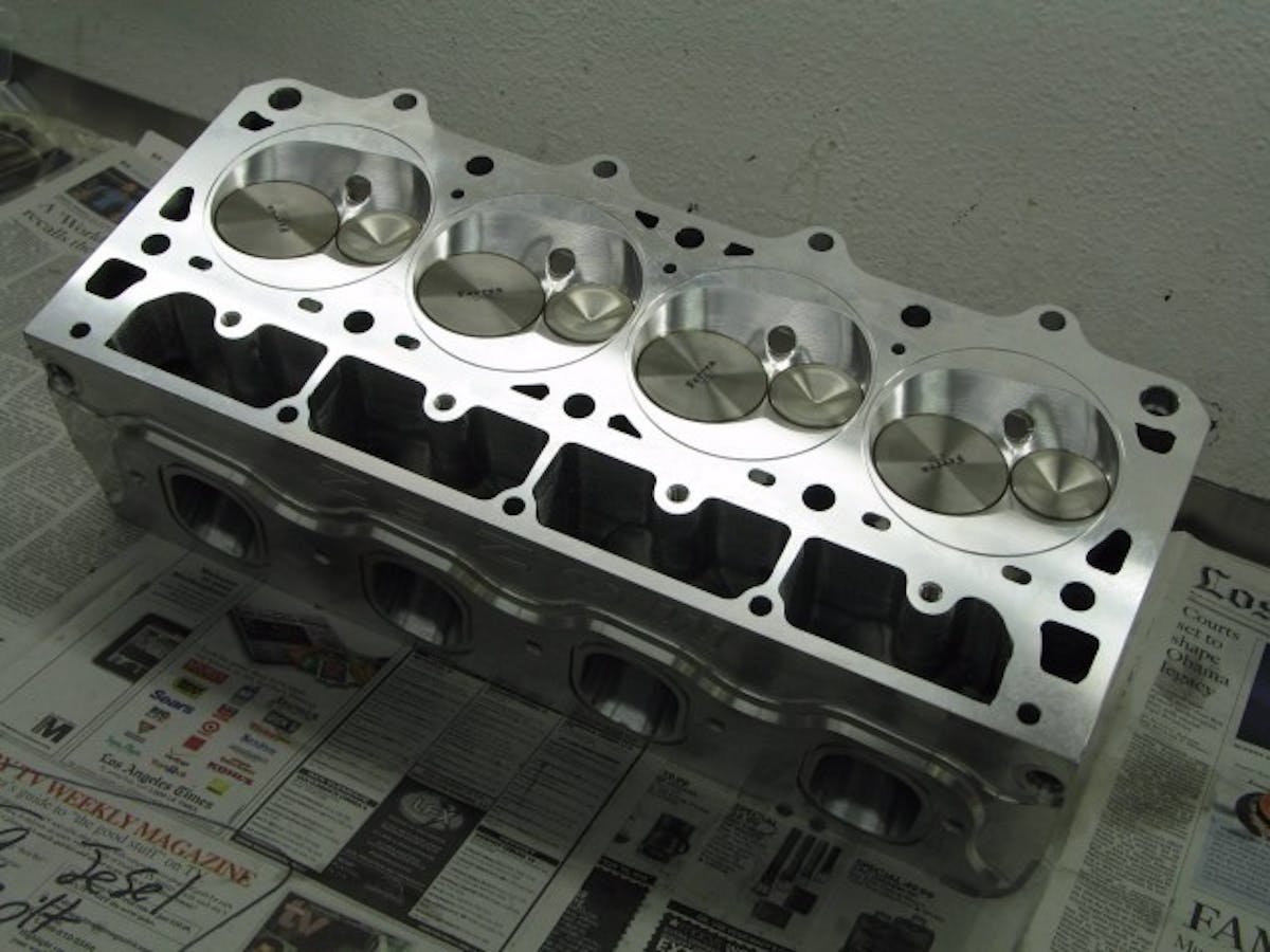 A close up of the deck of our Mast Mozez head. QMP cut small aluminum wedges and pressed them into the head to create a "dry deck" head. It's a costly but process but does not require welding that puts heat into the head.