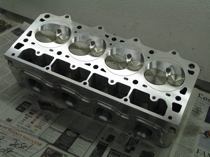 A close up of the deck of our Mast Mozez head. QMP cut small aluminum wedges and pressed them into the head to create a "dry deck" head. It's a costly but process but does not require welding that puts heat into the head.