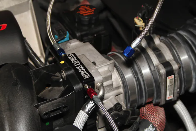 The Nitrous Express plate system for 3-bolt LS throttle bodies couldn't be much easier to install. It fits between the intake manifold and throttle body, and doesn't block any airflow like a single-nozzle wet system would.