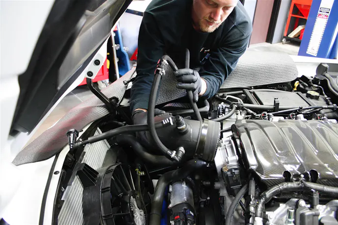 To begin, we had to say goodbye to our tried-and-true K&N intake system. To provide access for the new intake tubing, intercooler, and the supercharger itself, the bumper cover, fender liners and splash guards, and the radiator fan all get temporarily removed.