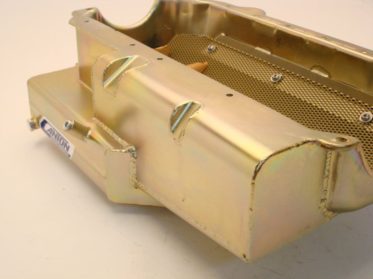 The "power pouches" or intends seen here on the side of the pan serve to reduce the parasitic power loss. While some aftermarket LS blocks allow for the use of features like these, the   skirted design of the stock LS block means windage trays have to play the role of keeping excess oil off of the crank.