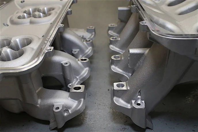 Here you can see that while the Holley Mid-Rise (left) has a runner design that requires a sharp curve, it's basically a straight shot from port to port on the Hi-Ram.