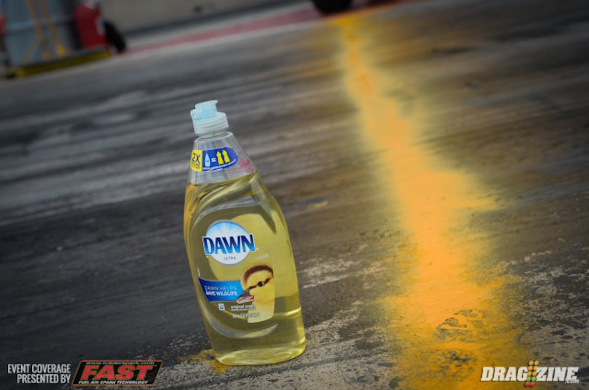 So, how do they make these cars get off the starting line as well as they do, in the absence of proper track prep? Well, an age-old street racing secret, racers use what's known as 'pimp juice', or typically a mix of traction compound (like VHT) and xylene (to help water it down a little) spread under the rear tires. After doing the burnout, a nice coating of pimp juice is covers the tire tread, giving racers just a little assistance planting the power on the starting line.