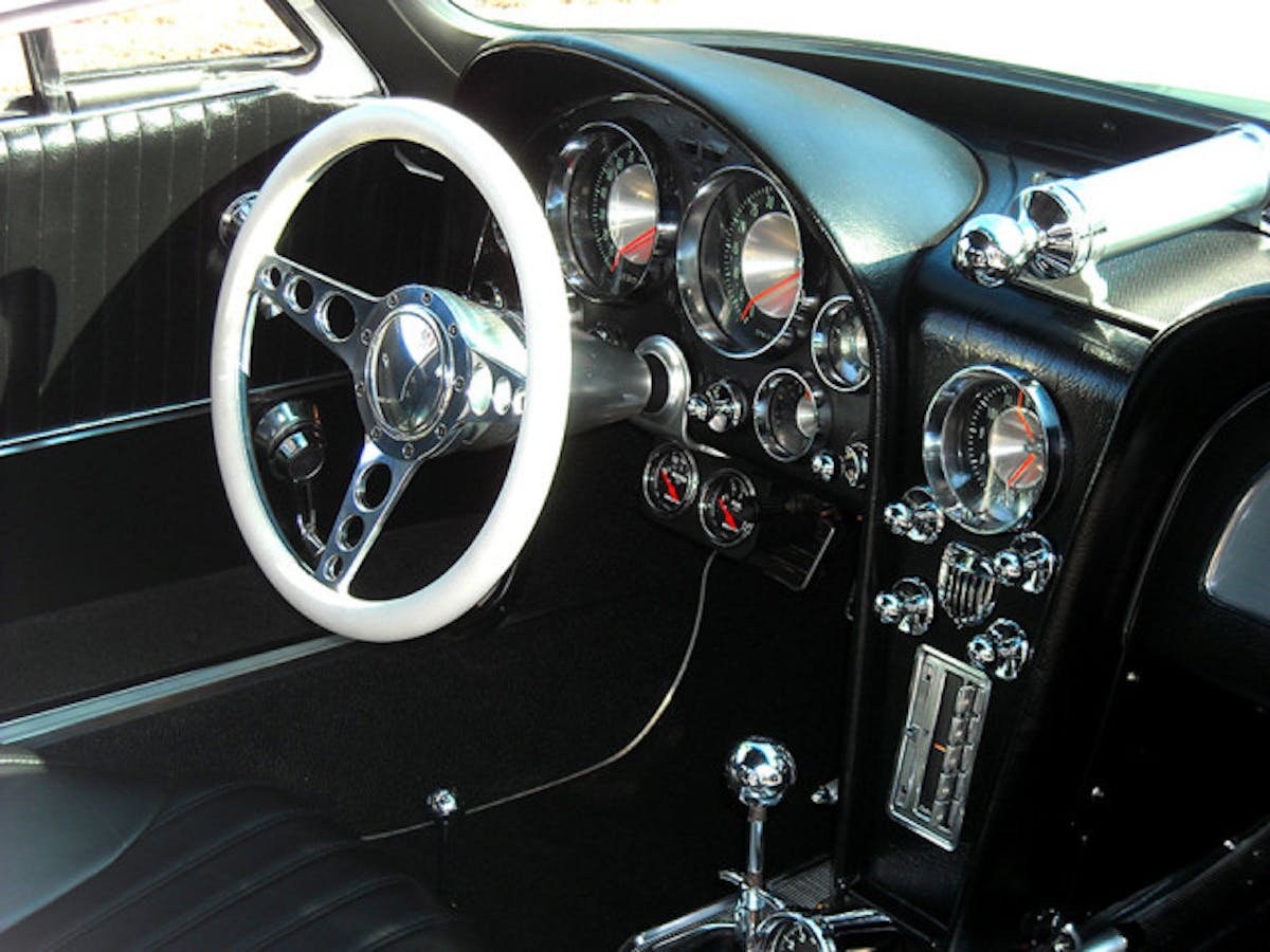 That’s no fire bottle on top of the dash, it’s a dirt track racing throw back piece of decoration. Settrella’s used a hand-operated fuel pump on his dirt racer for extra juice coming out of the curves! The white steering wheel and custom center kind of pulls the room together.