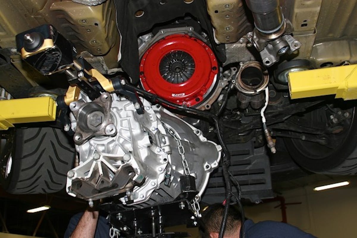 With the clutch all buttoned up, the gearbox can be hooked up to the drive train again. While you won't be able to see the sweet red paint job of the McLeod Racing clutch once everything is put back together, Mike will certainly get a benefit from it in both increased on-track confidence and a lack of grenaded transmissions piling up in his garage.