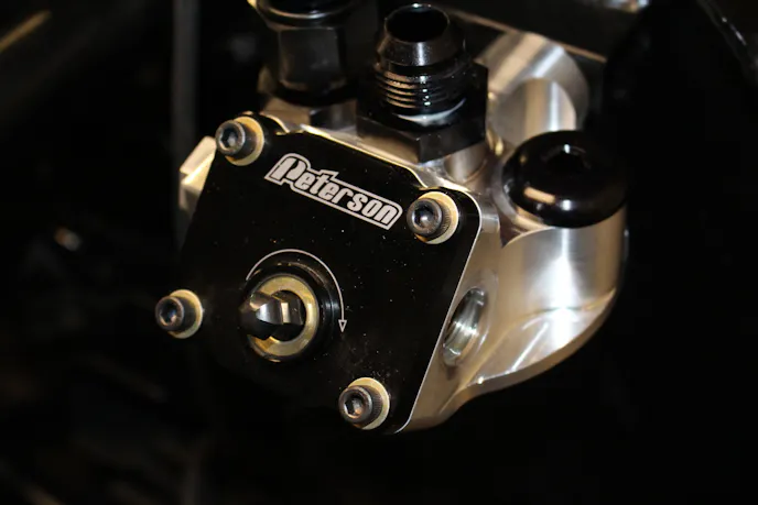 Peterson offers this super cool remote filter mount. It has a massive 1 1/2 inch outlet for full flow but the coolest feature is the small psud that sticks off the front. The mount has a dedicated line to the oil tank. A hand drill can be used to turn the spud, draw oil from the tank and pre-lube the engine. This can be done without having to cold crank an oil starved engine causing premature wear on the bearings.