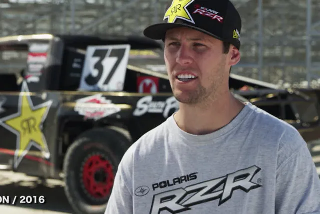 RJ Anderson and his short-course truck behind him.
