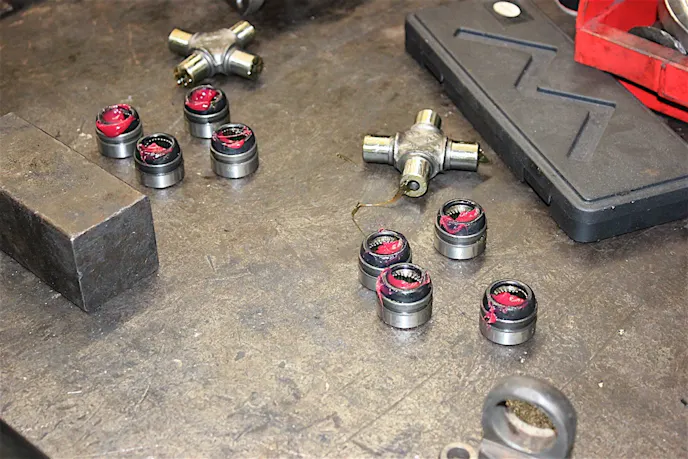New U-joints and caps get lots of grease before going back in.