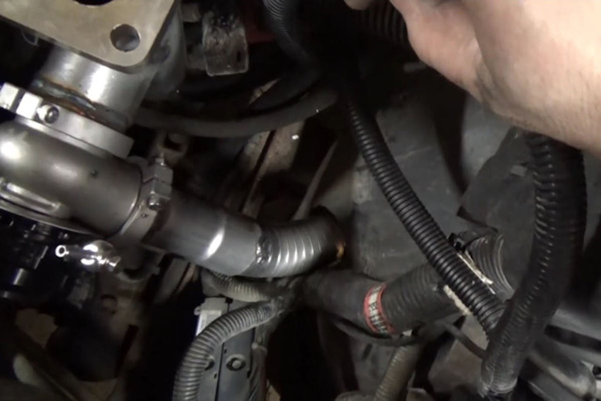 The dump tube routed to exit through the hole Craig cut in the inner fenderwell.