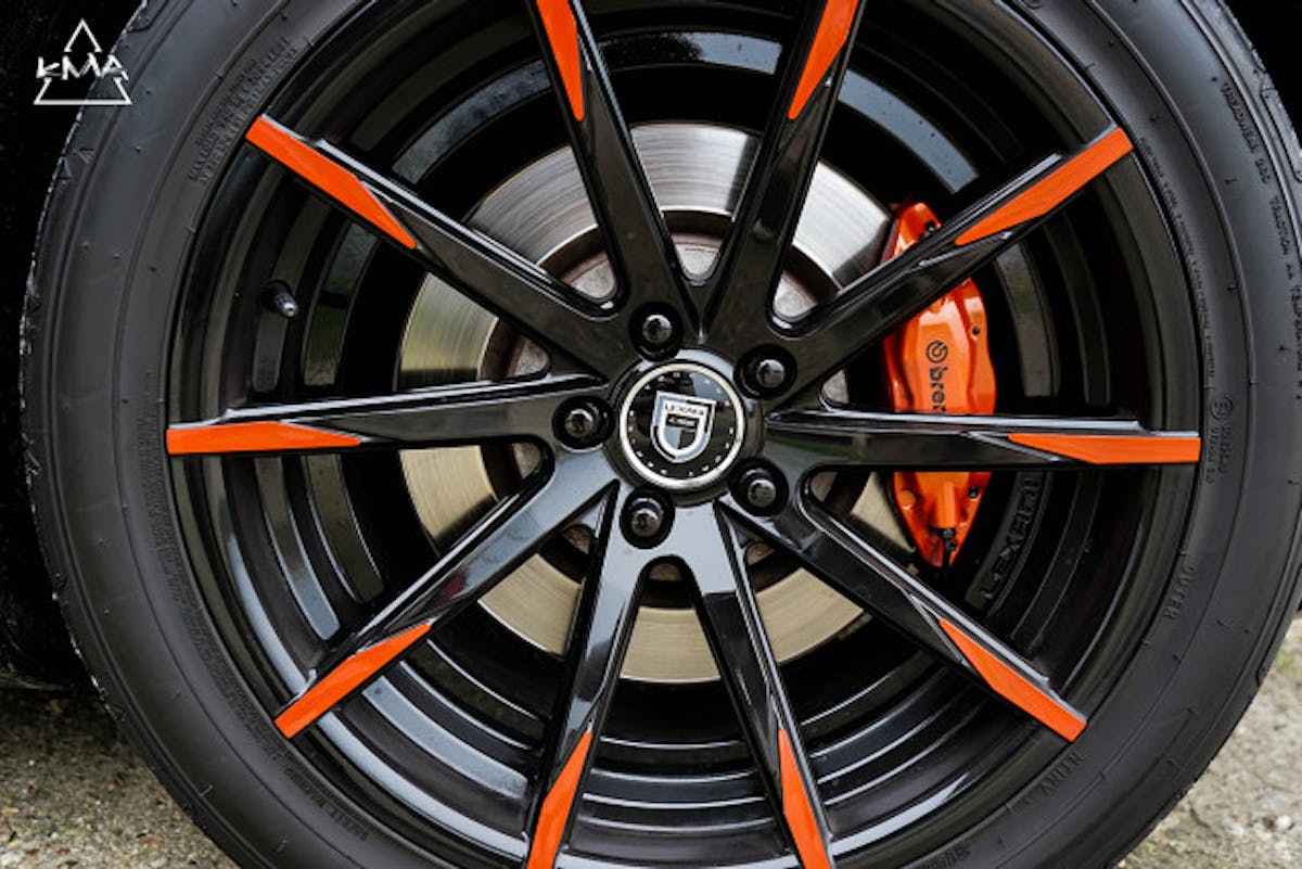 The Lexani CSS wheels in black and orange are an excellent counterpoint to the Inferno Orange Brembo calipers.