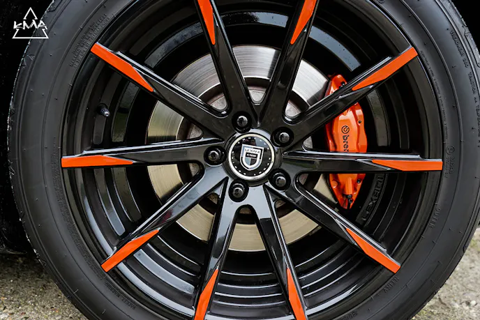 The Lexani CSS wheels in black and orange are an excellent counterpoint to the Inferno Orange Brembo calipers.