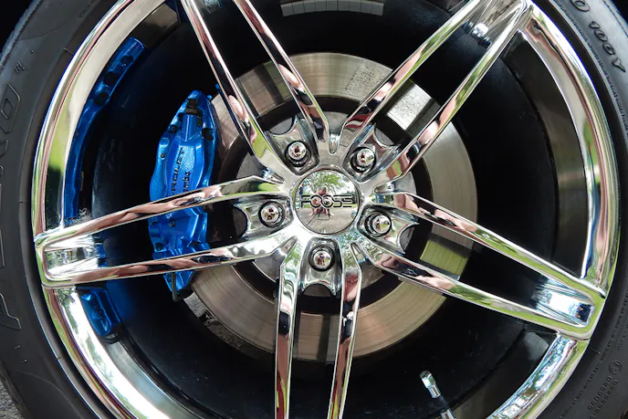 Chip Foose Stallion wheels covering a set of blue powder-coated Brembo calipers.