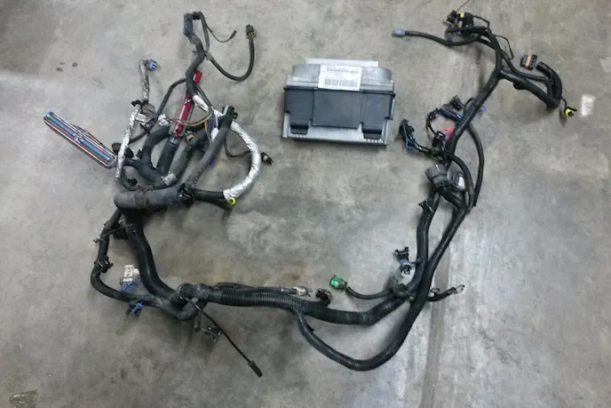 The harness and PCM from a '99 Camaro Z28 was bought and modified to fit the '01 C4. Image courtesy bigcommerce.com.