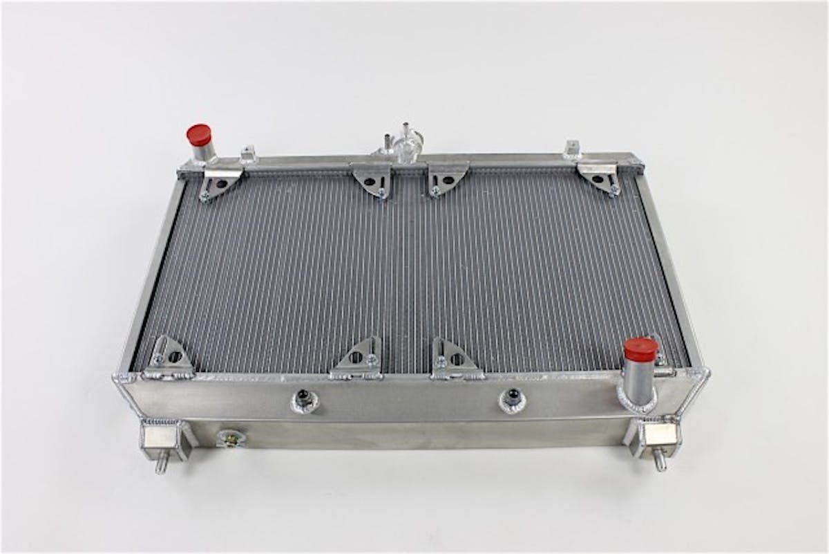 Be Cool's dual core radiator is some serious hardware, made from aircraft-grade aluminum here in the USA. It's a massive upgrade in capacity versus its OEM counterpart, which is a single core system that uses plastic tanks and some questionable build tactics.