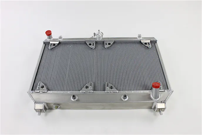 Be Cool's dual core radiator is some serious hardware, made from aircraft-grade aluminum here in the USA. It's a massive upgrade in capacity versus its OEM counterpart, which is a single core system that uses plastic tanks and some questionable build tactics.