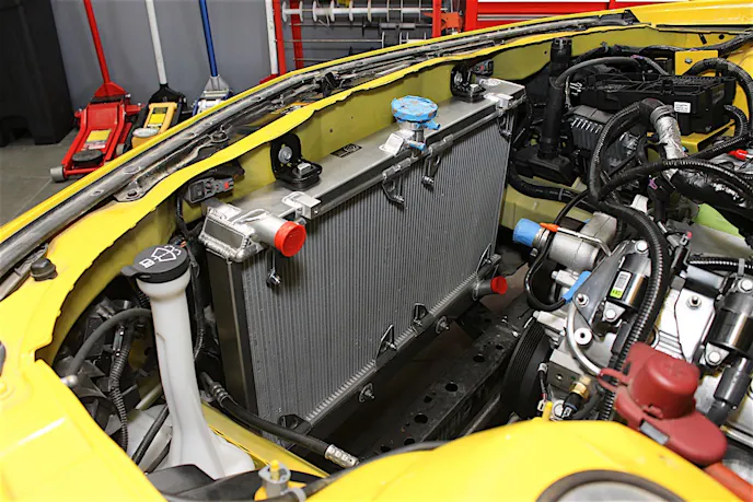 It's important to note that there are some differences between the 2010-11 and 2012-15 Camaros that affect which radiator you'll need. For '12 models and up the mounting AC condenser and fan was relocated, so while the radiators are the same, the bracketing is not. We ended up with a 2010-11 model by mistake but we were able to fabricate and weld on some mounts to solve the problem in the interest of saving time. However, if we'd had the right part on hand, this radiator would drop right in in exactly the same manner as the stock one did.