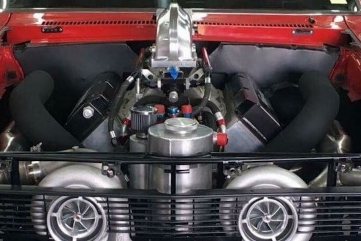 That ginormous throttle body elbow atop the Proline big block is mostly the reason for the aforementioned fiberglass hood. The elbow ingests cooled air from an intercooler located just behind the front seat.