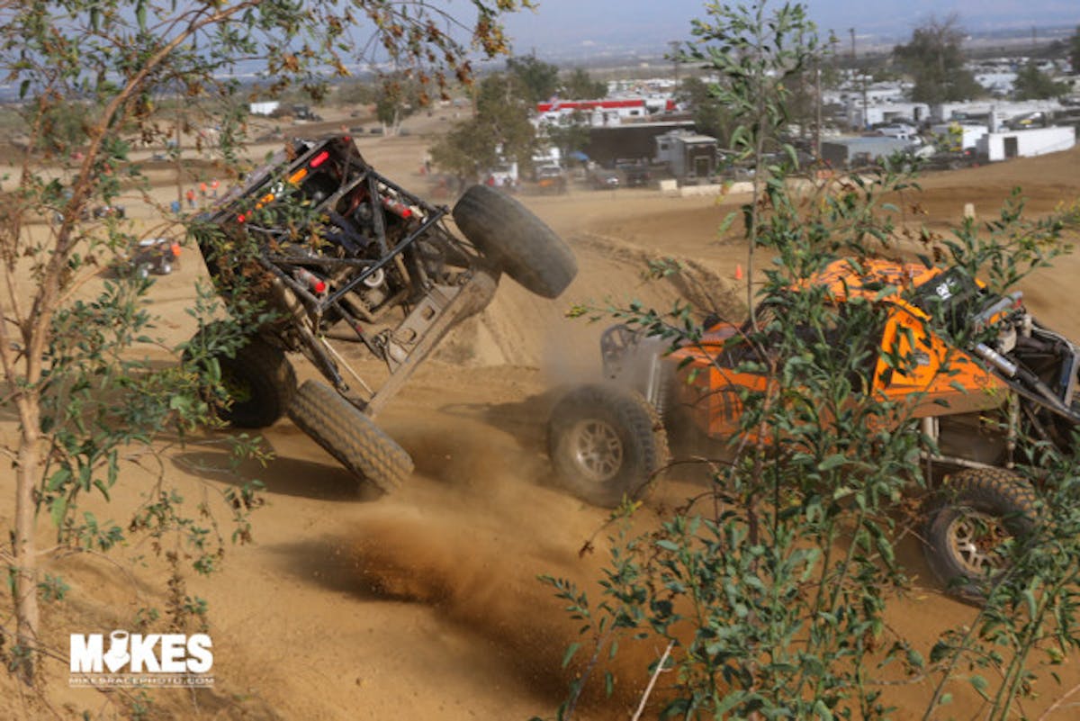 Wayland Campbell goes for a ride after making contact with the front tire on Tom Wayes' car.