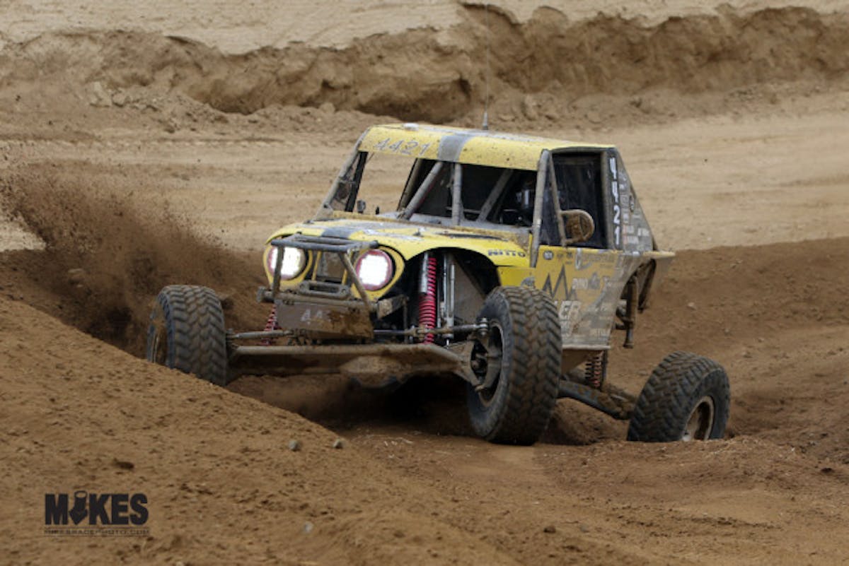 Erik Miller is nearly swallowed in a deep hole on the course. His straight axle front end shows the incredible steering angle it is capable of.