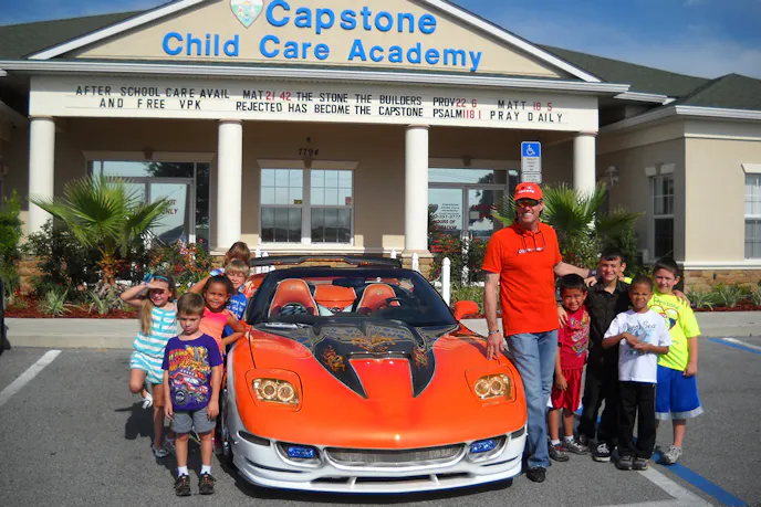 Tk Metz was a participant in "Drive Your Corvette to Work Day" last year. Here he is with some of the kids from the day care center he works at. Image courtesy Corvette Museum.