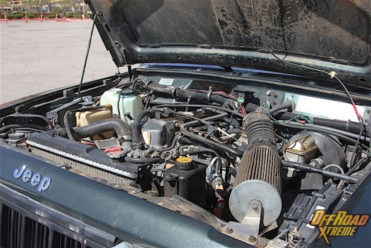 Although some of components were interchangeable between the AMC 258 cubic inch six-cylinder and the 2.5-liter four pot, the latter was not a cut down version of the big six. The 2.5-liter seen here has a shorter stroke and larger bore, the valves are larger and the pistons are unique to the four cylinder. AMC/Chrysler engineer Roy Lunn explained in an interview for a book on the history of Jeeps that they wanted as much displacement as possible within the confines of bore centers of the tooling for power and torque, and the only parameter they could influence substantially was stroke. Accordingly, they picked the largest bore and stroke in order to get 2.5 liters out of it.