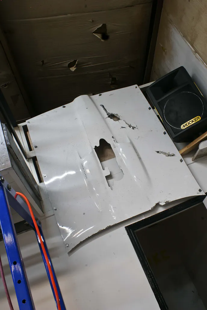 The hood from the Crow hangs on the wall in the back corner of Midwest Streetcars Automotive. It's a somber reminder of the wild ride Chief endured and the physical pain he's going through on a daily basis.