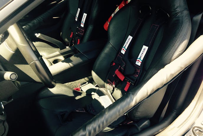 Roll cage, Corbeau racing seats, five-point racing harnesses, and fire suppression are all required by sanctioning bodies.