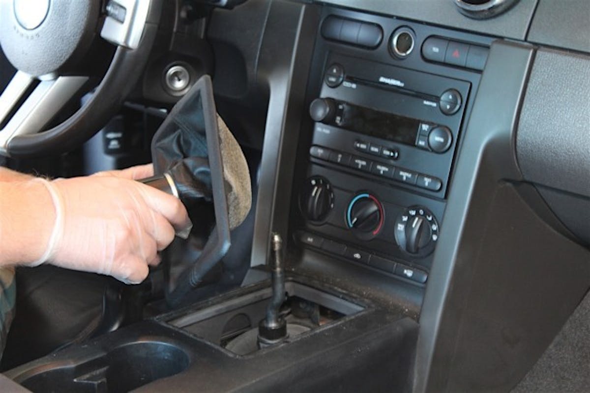 Next up, remove the rubber dust boot from the shifter by simply pulling up. Be aware, there's probably going to be a bit of dirt and/or grease on this thing, so you may want to have a rag near by just in case.