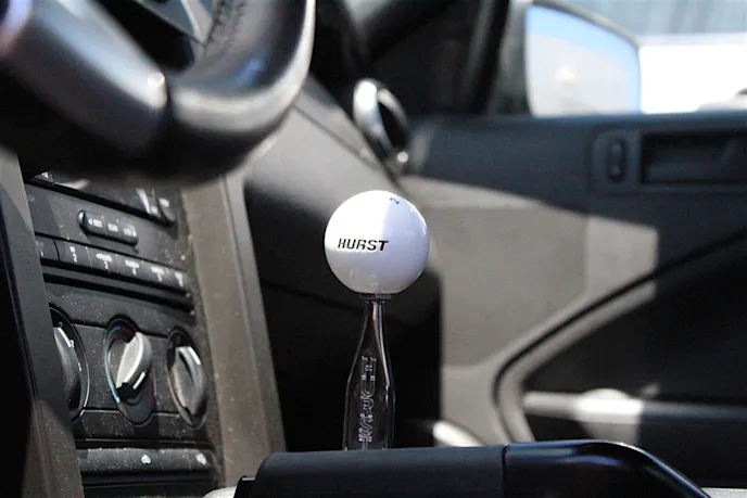 Post installation of our new Hurst Billet Plus shifter, we had a chance to take the car out and get a feel for the new shifting experience. To put it lightly, this shifter is one tough setup. The billet construction feels extremely durable to the touch, unlike the limp factory stamped steel piece.