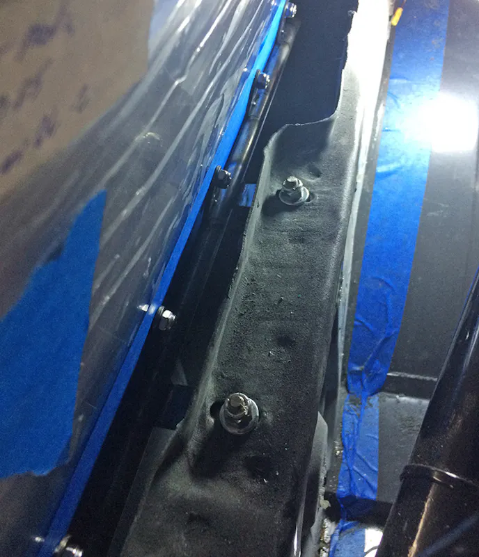 This inner body panel and the two original mounting holes serve as the anchor for our quarter windows. To build our bracket, we mocked the window and place and measured the distance from the bolt centers out to the window. Because this window isn't semi-adjustable like the door windows, we had to have this accurate.