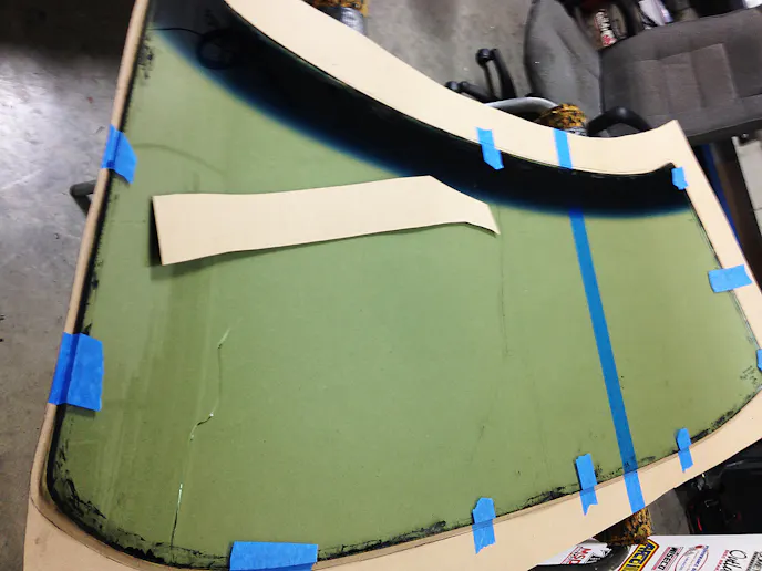 We began the windshield work by tracing the OEM glass onto our cardboard template, which we'd later transfer onto the polycarbonate.