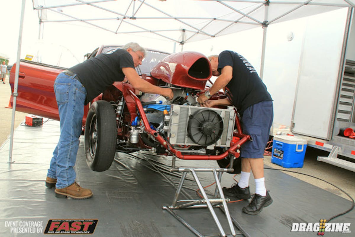 NA 10.5 Racer Leonard Long has good mile per hour but had trouble on the starting line the past few events and has changed the shocks and springs out back in effort to fix the issues there. They were just putting on the hood scoop in preparation for round two qualifying.
