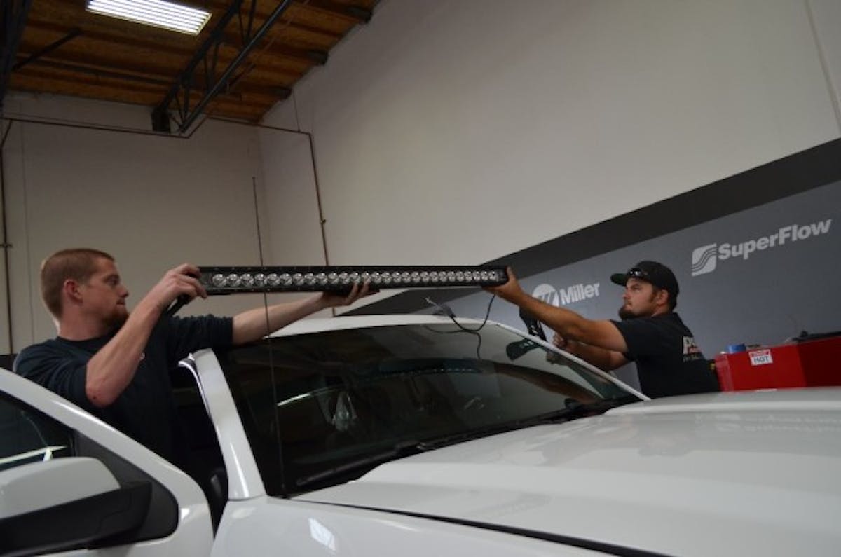 An extra pair of hands will help in positioning the light bar.