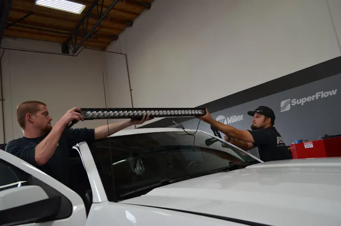An extra pair of hands will help in positioning the light bar.