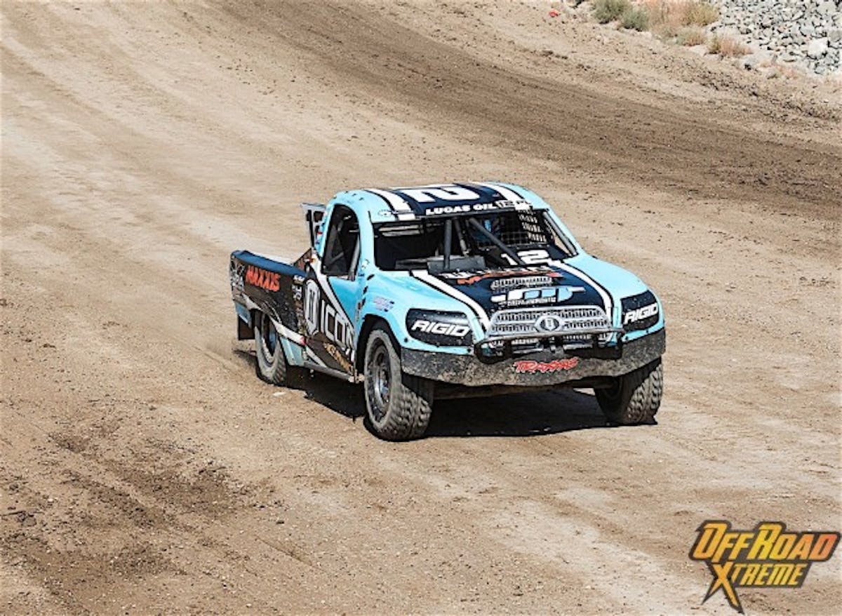 Brock Heger brings the no. 12 Pro Lite truck down the straightaway in front of the grandstand.